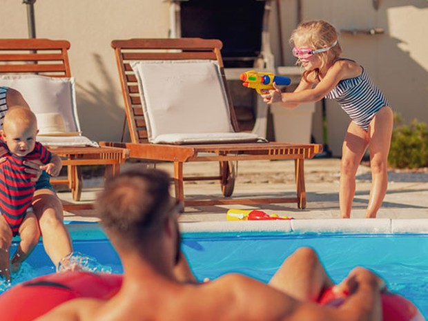 family playing in pool