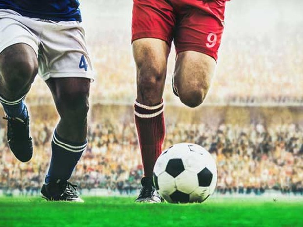 Twee voetbalspelers rennen achter bal aan