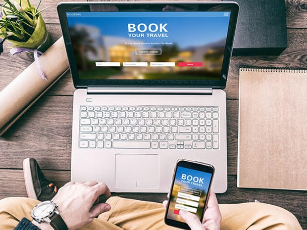 Man boekt hotel op laptop
